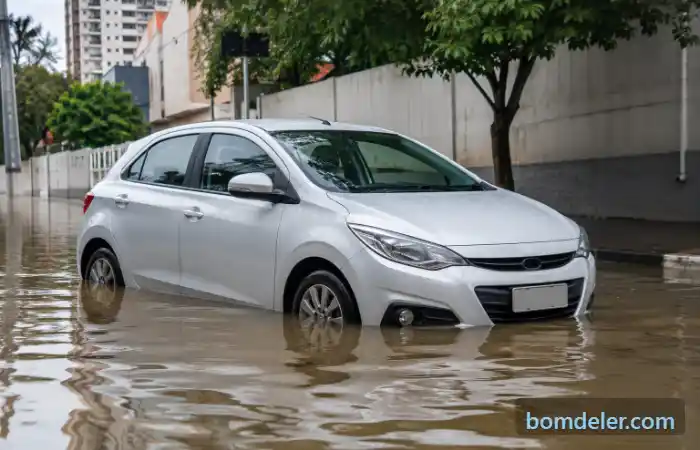 Seguro de carro cobre enchente com automóvel claro parado em rua alagada.