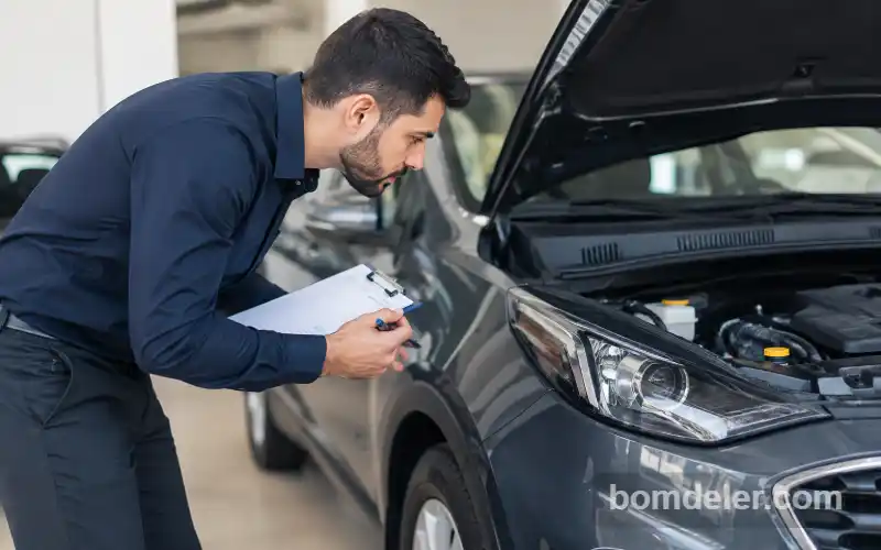 Profissional realizando vistoria em carro para análise de seguro para carro de leilão.